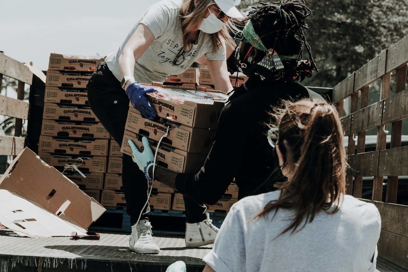 Volunteers packing donation boxes with joy